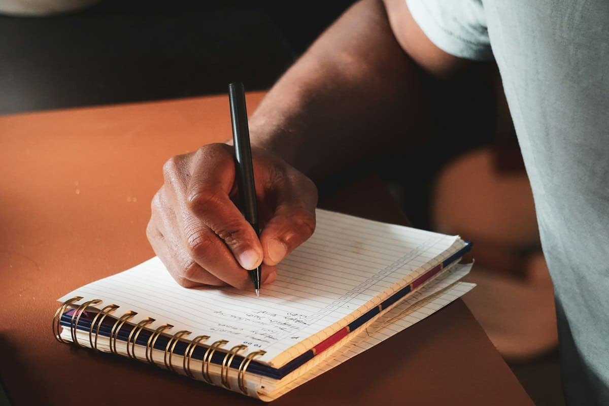 A man writing his plans in a notebook